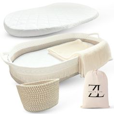 the baby bed is next to two pillows and a bag