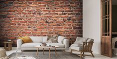 a living room with brick walls and furniture