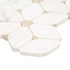 a close up view of a white marble mosaic tile