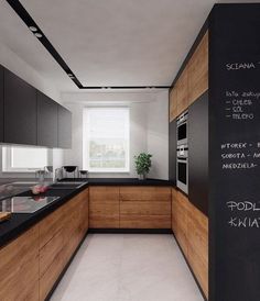 an image of a kitchen with black and white decor on the counter top, and chalk writing on the wall