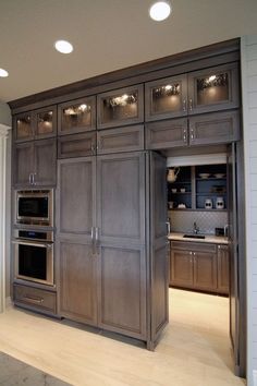 a kitchen with wooden cabinets and stainless steel appliances