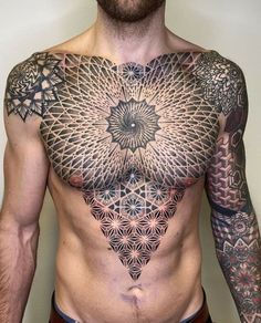 a man with tattoos on his chest and arms