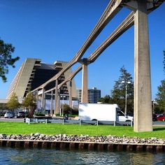 a white truck is parked on the grass by the water