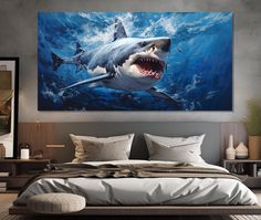 a large shark painting on the wall above a bed