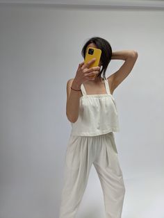 The Sabina Top is a boxy cropped tank created from our beloved and seasonless raw silk fabric. The Sabina boasts an effortless and easy cropped fit perfect for pairing with high-waisted trousers and shorts. Worn alongside our newly released Lena Pants in Raw Silk or the Townes Shorts - the Sabina is sure to become your next go-to piece for year-round wear! 100% Silk Made in USA Dry Clean or hand wash in cool water separately, lay flat to dry. The occasional shade or darker weaving variations are Versatile Relaxed Fit Crop Top For Day Out, Chic Cropped Hem Crop Top For Summer, Chic Spring Crop Top With Elastic Waistband, Chic Cropped Tank Top For Summer, Summer Cropped Linen Tank Top, Chic Slightly Cropped Tank Top For Summer, Chic Cropped Tank Top For Loungewear, Chic Relaxed Fit Crop Top For Loungewear, Versatile Sleeveless Lounge Crop Top