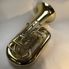 an image of a brass french horn on a white background