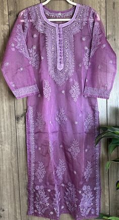 Purple Chikankari kurta on organza! Delicate hand embroidery and mukaish add ons on lightweight sheer fabric. Includes a shantoon liner. Length- 47 inches Organza Kurta With Resham Embroidery For Diwali, Diwali Resham Embroidery Organza Kurta, Organza Straight Kurta With Zari Work, Straight Organza Kurta With Zari Work, Fitted Embroidered Purple Kurta, Fitted Purple Embroidered Kurta, Organza Kurta With Intricate Embroidery For Eid, Intricate Embroidered Organza Kurta For Eid, Intricate Embroidery Organza Kurta For Eid