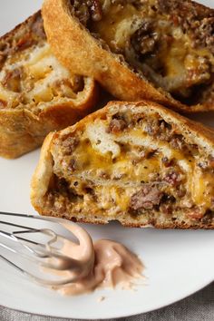 a white plate topped with meat and cheese muffins