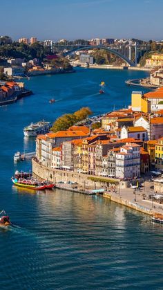 an aerial view of a city with boats in the water