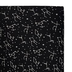 a black blanket with white stars and zodiac signs printed on the front, as well as an astro sign