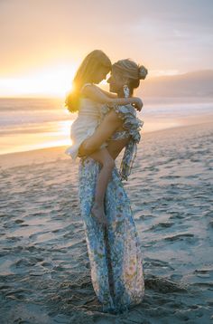 mother and daughter on the beach at sunset