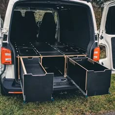 the back end of a white van with its cargo compartment open