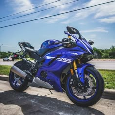 a blue motorcycle is parked on the side of the road