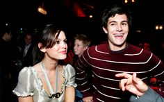 a man standing next to a woman at a party