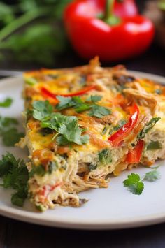 a white plate topped with an omelet covered in veggies