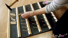 a woman is working with wooden dows on the floor