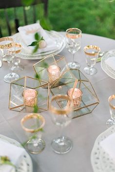 a long table is set with flowers and place settings for the guests to sit at