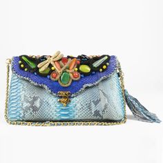 Kiss The Blues Goodbye With This Stunning Genuine Python Shoulder Bag. Complete With Dazzling Beading, Gold Hardware And Signature Python Tassel, This Purse Is Sure To Turn Some Heads. Features: 10"W X 6"H X 2"D Python Woven Shoulder Strap Sueded Cotton Lining Signature Python Tassel Hand Beaded Flap Luxury Blue Pouch Satchel, Luxury Blue Flap Bag For Travel, Designer Light Blue Shoulder Bag With Detachable Strap, Luxury Blue Shoulder Bag, Blue Flap Bag With Dust Bag, Luxury Blue Flap Bag With Detachable Handle, Designer Light Blue Bags With Detachable Strap, Blue Crossbody Bag With Dust Bag Included, Designer Light Blue Bag With Detachable Strap