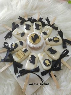 a white cake with black and gold decorations on it