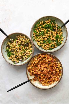 three bowls filled with different types of food on top of a white countertop next to black chopsticks