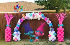 an inflatable balloon arch decorated with pink and blue balloons for a birthday party