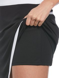 Featuring a flattering wrap design and eye-catching color blocking, this women’s golf skort from Callaway will be a striking addition to your athletic wardrobe. The skort is made from an interlock knit fabric that offers natural stretch to let you bend and twist without feeling constricted. The material has sun protection technology to help block harmful UV rays, and it wicks away moisture to help keep you comfortable and dry. Truesculpt™ technology helps to create a smoother, more streamlined s Black Sporty Mini Swim Skirt, Short Athleisure Tennis Dress, Sporty Black Mini Swim Skirt, Short Tennis Dress For Sports, Sporty Black Tennis Shorts, Black Athleisure Tennis Skort, Black Athleisure Skort For Tennis, Sporty Black Tennis Skort, Sporty Black Skort For Tennis