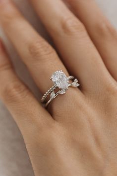 a woman's hand with a diamond ring on it