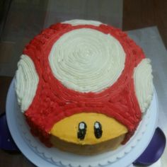 a cake with white frosting and red decorations