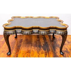 an ornately decorated coffee table on wooden floors