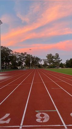 an empty running track with the sky in the background