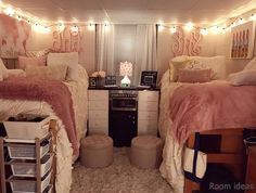 two twin beds in a dorm room with lights on the ceiling and rugs covering the floor