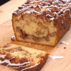 a loaf of apple fritter bread sitting on top of a wooden cutting board