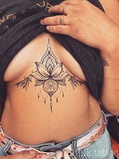 a woman with a tattoo on her stomach