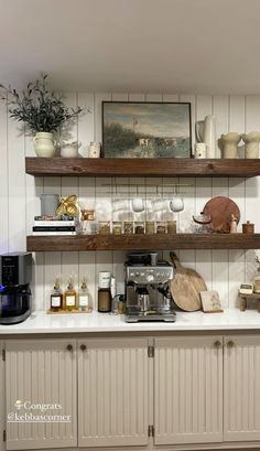 a kitchen with open shelving and wooden shelves filled with items on top of it