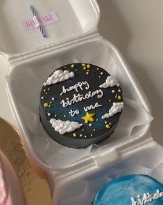 a birthday cake in a plastic container on a table