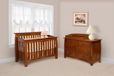 a baby crib and dresser in a room