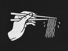 a hand holding chopsticks with noodles on it