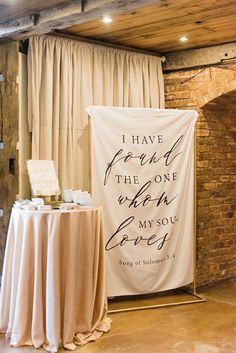 a sign that says i have found the one who loves you next to a table