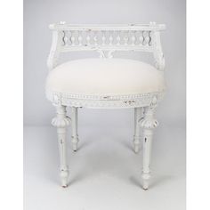 an antique white vanity chair with upholstered back and seat cushion, possibly from the early 20th century