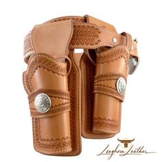 a pair of leather holsters with metal buckles on the sides and an intricately embellished design