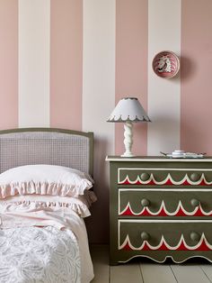 a bedroom with pink and green striped walls