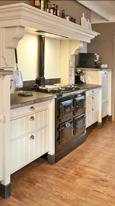 a large kitchen with white cabinets and an oven