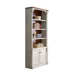 a white bookcase with two doors and some books on the bottom shelf, in front of a white background