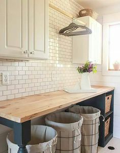 the kitchen counter has three buckets on it