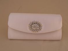 Beautiful purse for the bride's necessities, it has a silver metal chain; Delicately adorned with a crystals and pearls brooch, Colors: White, or Ivory Size: 8.5'' wide x 4 1/4'' high FINAL SALE, NO RETURNS, NO EXCHANGES! INTERNATIONAL ORDERS: The Buyer is responsible for all Customs and Duty Tax Fees on item/s ordered. I suggest you contact and consult, your local Customs Office for applicable charges before ordering. I am not responsible for your Country's Duty Taxes. I always ship First Class Silver Evening Bag With Pearl Handle For Wedding, Silver Wedding Clutch With Pearl Handle, Silver Pearl Wedding Bag, Pearl Silver Wedding Bags, Silver Pearl Wedding Bags, White Clutch Bag, Satin Handbag, Hot Pink Butterfly, Formal Clutch