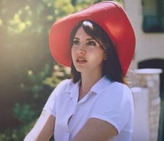 a woman wearing a red hat and white shirt