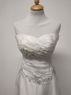 a white wedding dress on a mannequin