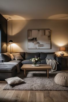 a living room filled with furniture and a painting on the wall above it's coffee table