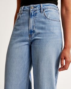 Our Curve Love high rise cropped wide leg jeans in a medium wash with a raw-cut hem. This fit features a 10.5” high rise, is relaxed at the waist and hips, and eases into a wide, full-length leg shape with a cropped length. Our Curve Love styles add an additional 2” at the hip and thigh to allow room for your curves and eliminate waist gap. This jean is made from our super light drapey denim fabric, which features a super soft lightweight rigid denim. Medium Wash Wide Leg Cropped Jeans, Medium Wash Cropped Bottoms For Everyday, Wide Leg Cropped Jeans In Medium Wash, Light Wash Wide Leg Mom Fit Bottoms, Everyday Wide Leg Flare Jeans With Frayed Hem, Everyday Cropped Leg Flare Jeans, Everyday Mom Fit Wide Leg Bottoms, Mom Fit Wide Leg Bottoms For Everyday, Spring Wide Leg Mom Jeans