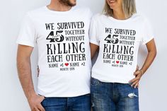 two people wearing t - shirts that say we survived together without killing each other with hearts